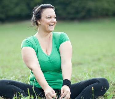 Woman sitting on grass smiling